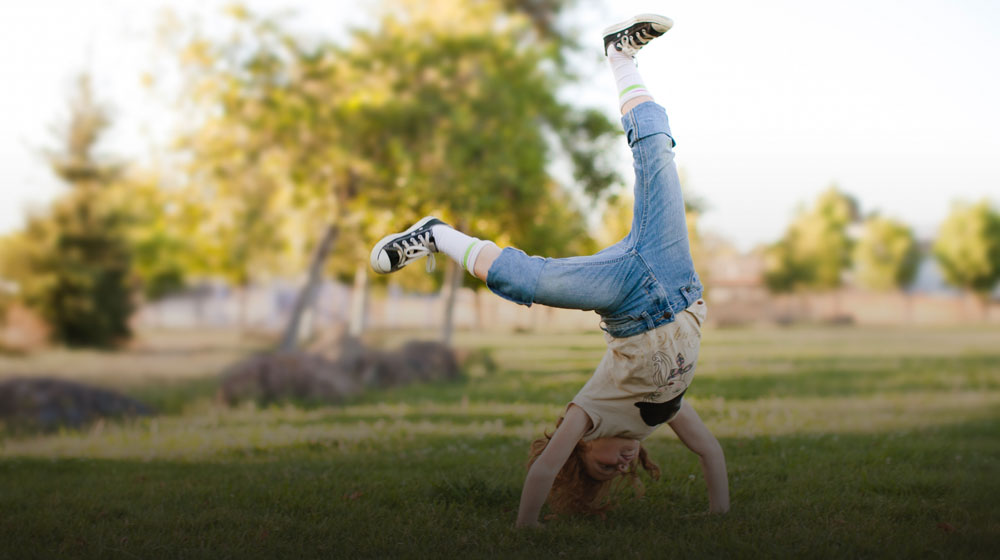 Child Doing a Somersault in an Open Field