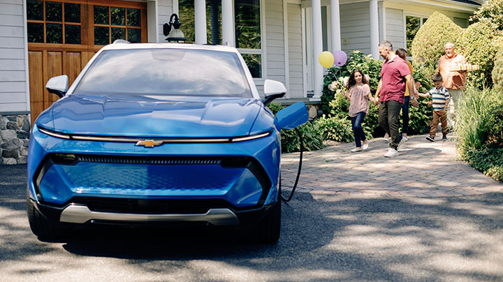 The 2023 chevy Blazer EV Charging in the Driveway of Family Home