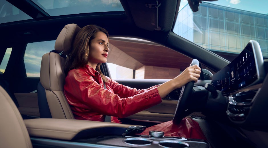 A Passenger View of a Woman Driving the Cadillac LYRIQ in the City